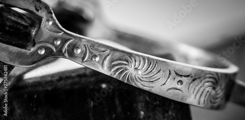 Close up of Silver stirrup with engraved detail in black and white