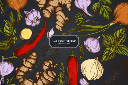 Floral design on dark background with onion, garlic, pepper, greenery, ginger, basil, rosemary