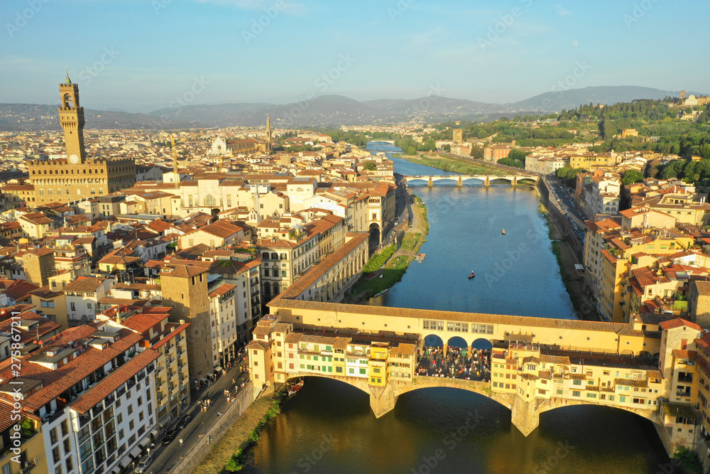 Florence, Tuscany, Italy - 15 June 2019. Aerial view of the Arno river and Ponte Vecchio bridge at sunset