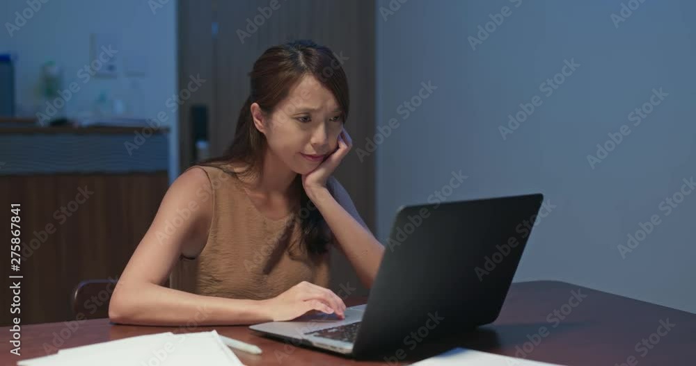 Woman feel annoy of using laptop computer at home in the evening Woman feel annoy of using laptop computer at home in the evening