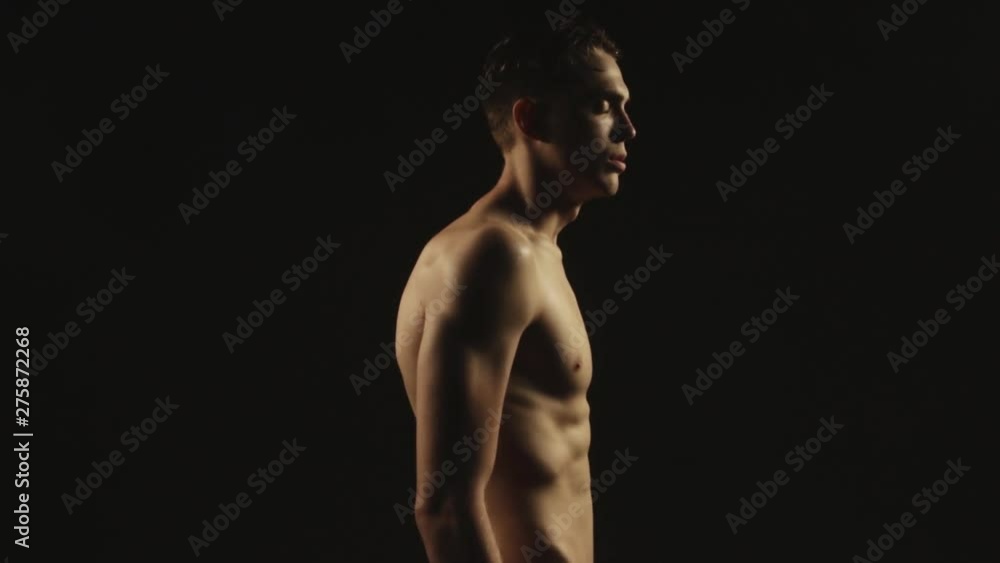 Sexy sport stripped guy in water drops with smoke on isolated black background Sexy sport stripped guy in water drops with smoke on isolated black background