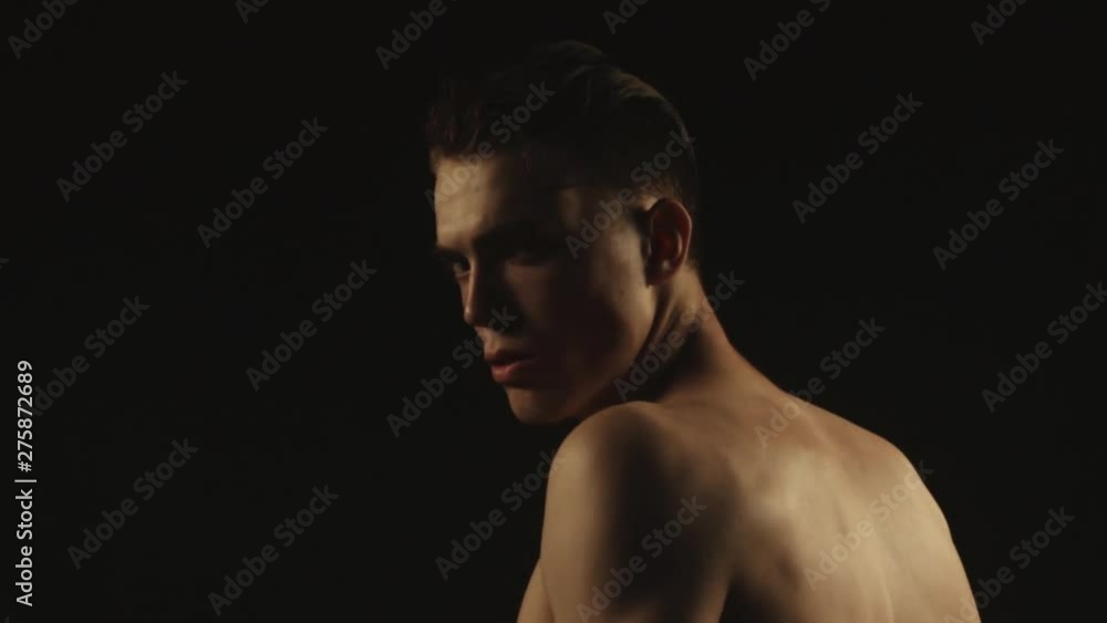 Sexy sport stripped guy in water drops with smoke on isolated black background Sexy sport stripped guy in water drops with smoke on isolated black background