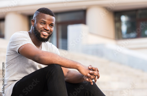 Portrait of african guy student waiting for lessons