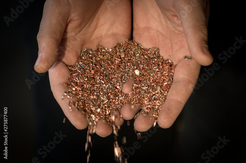 Copper shavings in the hands of the workers.