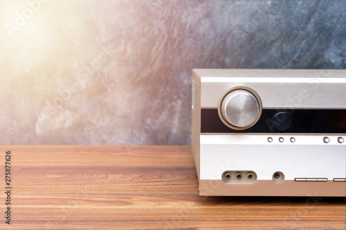 Obraz na płótnie Half front side AV receiver with volume and AUX Plugin on wood table
