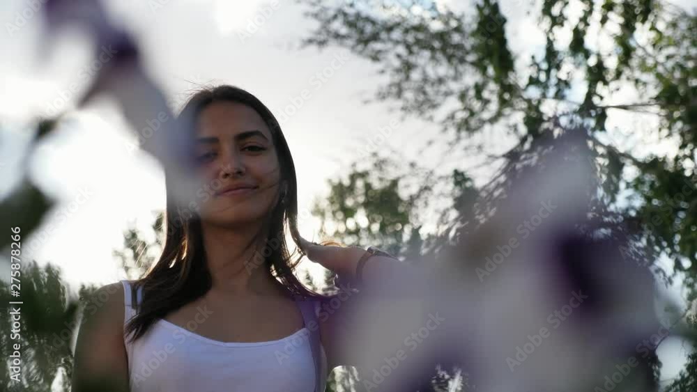 half-silhouette portrait of young pretty woman with brunette hair in the garden on the cloudy sky background in the evening half-silhouette portrait of young pretty woman with brunette hair in the garden on the cloudy sky background in the evening