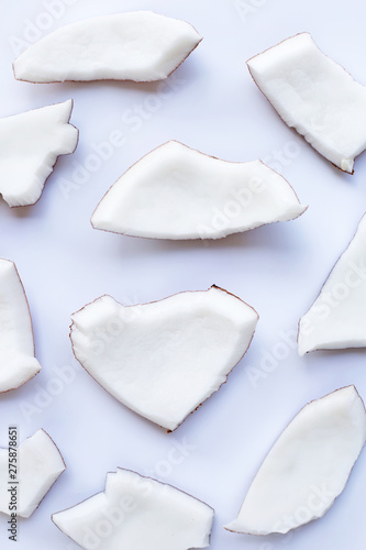 Coconut pieces on white background.