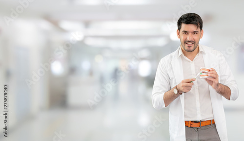 Young male dentist working in dental clinic. Dentistry care and medical service concept. photo