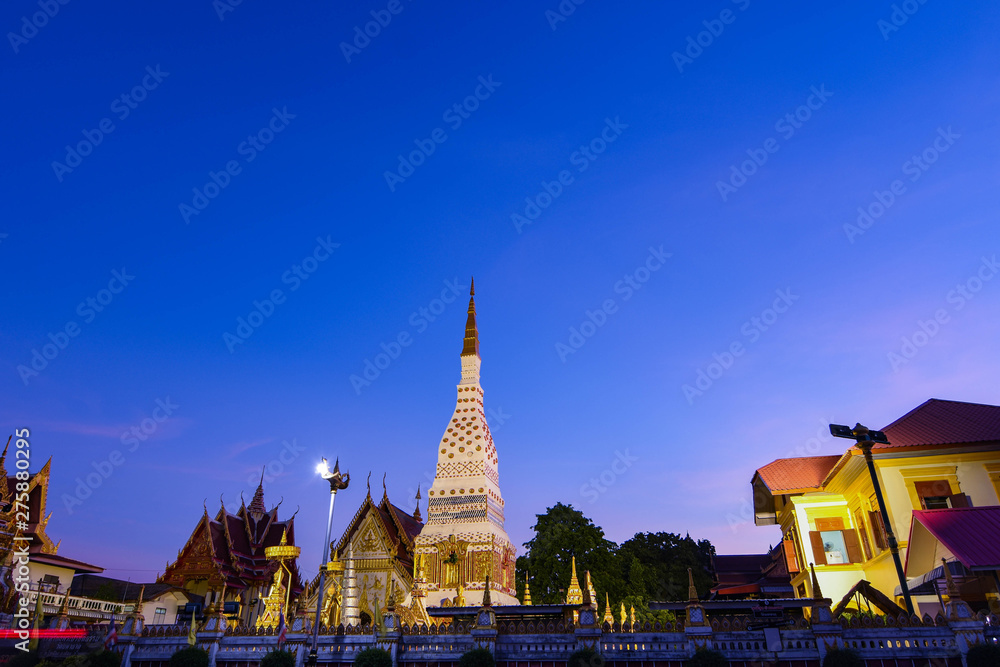 Fototapeta premium Phra Mahathat, along the Mekong River, Nakhon Phanom Province, amidst the sport lights Lights from the headlights, cars and the sky at night