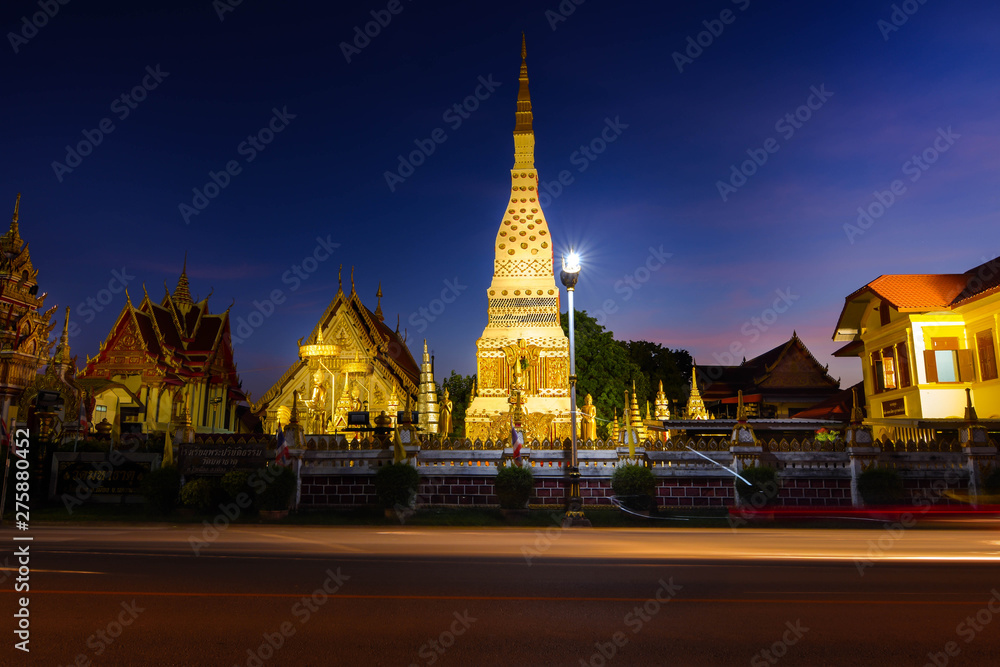 Phra Mahathat, along the Mekong River, Nakhon Phanom Province, amidst the sport lights Lights from the headlights, cars and the sky at night