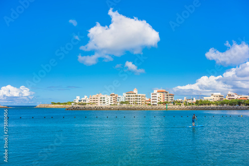 man doing paddle surfing in the Hamakawa fishing port in the vicinity of the American Village in Chatan City of Okinawa. photo