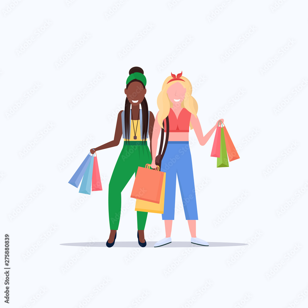 mix race women holding colorful paper bags couple girls carrying purchases big sale shopping concept flat full length