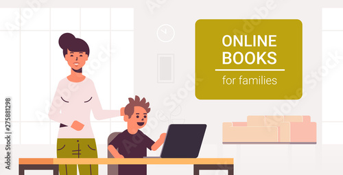 mother and son using laptop reading online books for family e-learning concept woman helping his child to do homework modern living room interior flat portrait horizontal