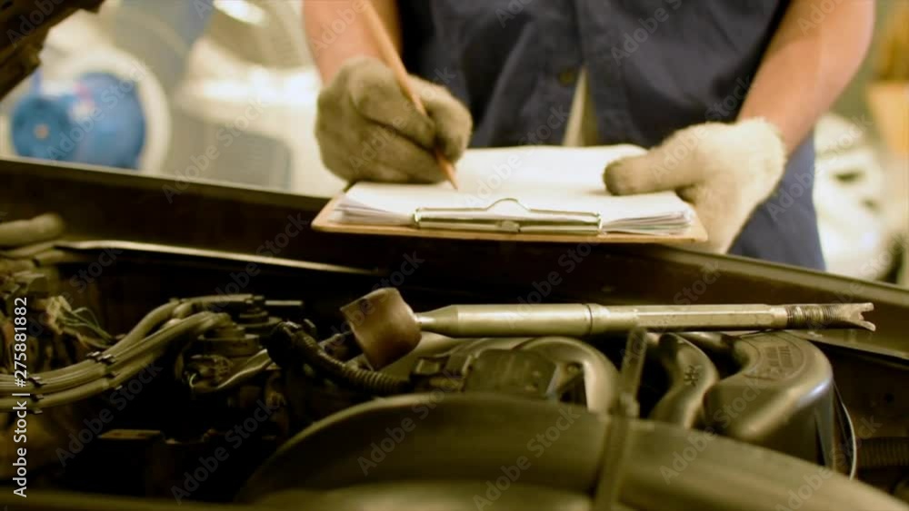 Man asian Checking Inspection period with car engine in showroom of   thai for automotive automobile car service video