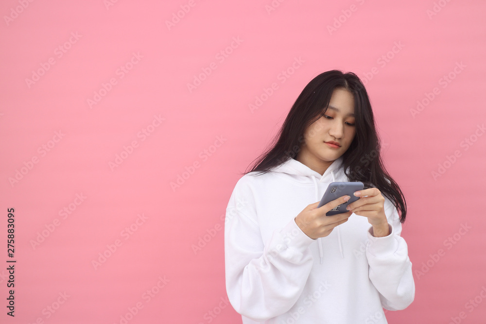 happy excited glad to receive text message informing about salary, rejoices good news, stares at mobile phone, actively from happiness, Beautiful Asian models over pink background for advertising c happy excited glad to receive text message informing about salary, rejoices good news, stares at mobile phone, actively from happiness, Beautiful Asian models over pink background for advertising c