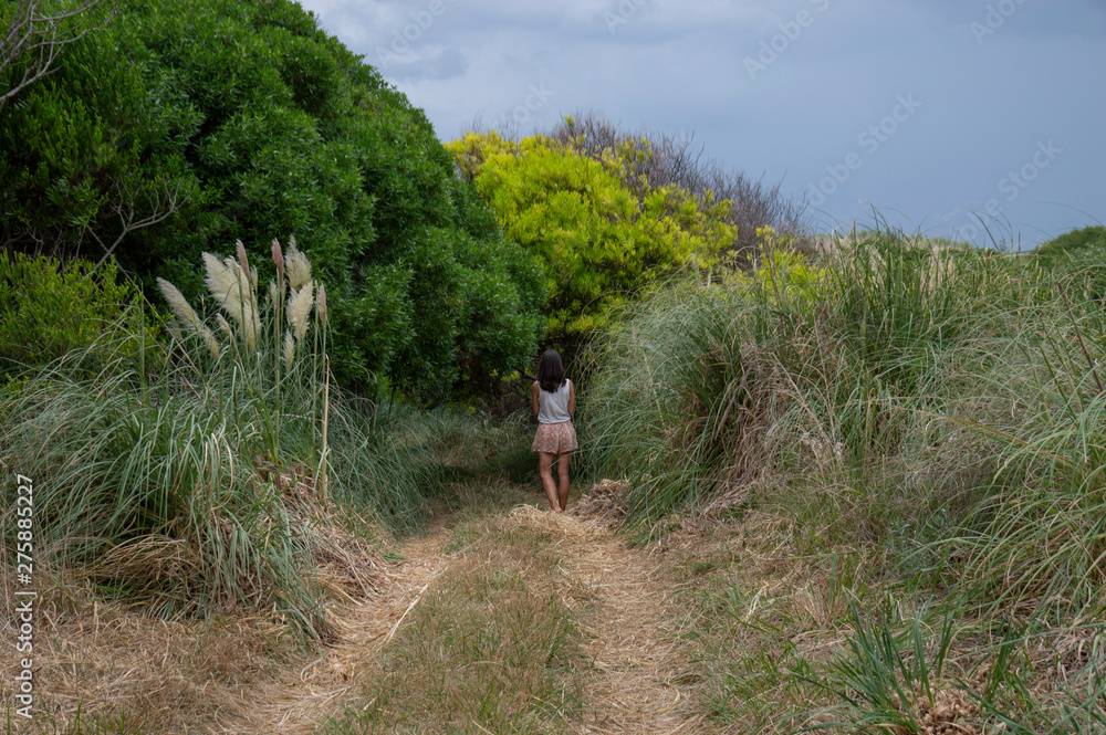 Young woman walking in the ecological reserve on the beach, in Mar Chiquita, Buenos Aires, Argentina