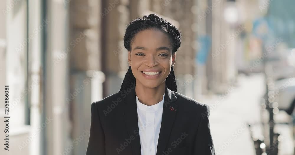 Portrait of stylish African American business woman standing on the old ...