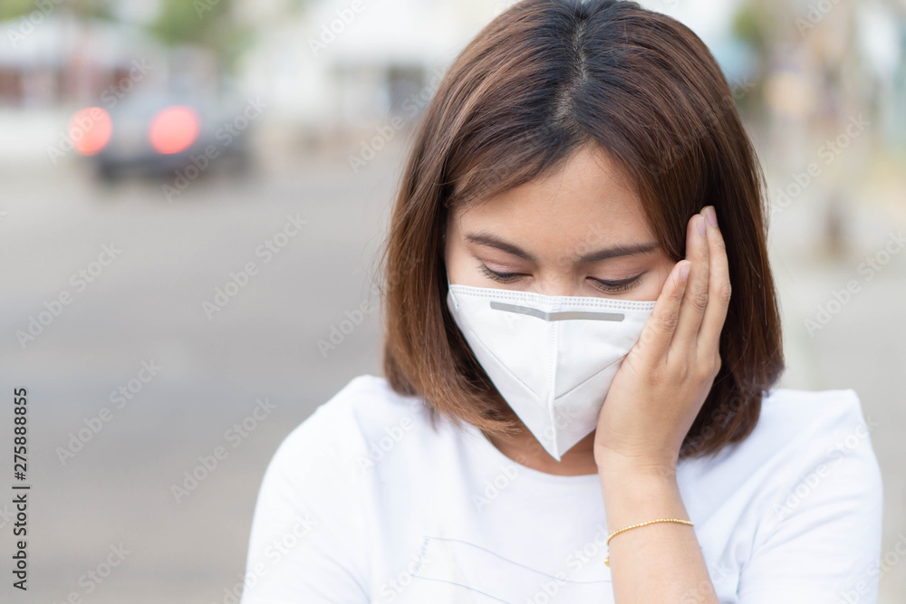 Closeup woman wearing face mask for protect air polution, health care and medical concept Closeup woman wearing face mask for protect air polution, health care and medical concept