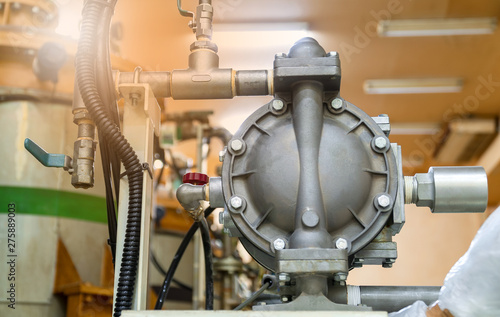 Air pressure pump installed for transferring chemicals in industrial factory.