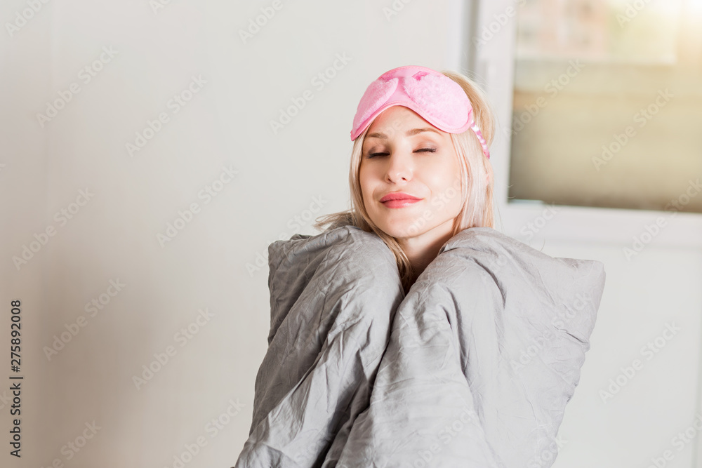 Happy woman sitting in bed at home Happy woman sitting in bed at home