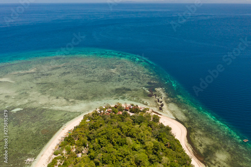 Mantigue Island, Philippines. Tropical island with white sandy beach and coral reefs. Seascape, view from above.