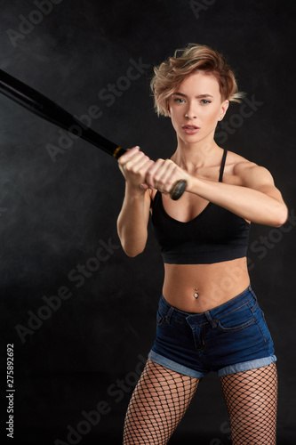 blonde athlete is standing in playing position. close up portrait. isolated black background