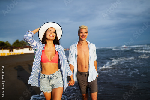 Happy young couple having fun and love on the beach