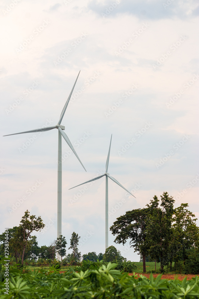 Fototapeta premium Wind turbine farm power generator in beautiful nature landscape for production of renewable green energy is friendly industry to environment.