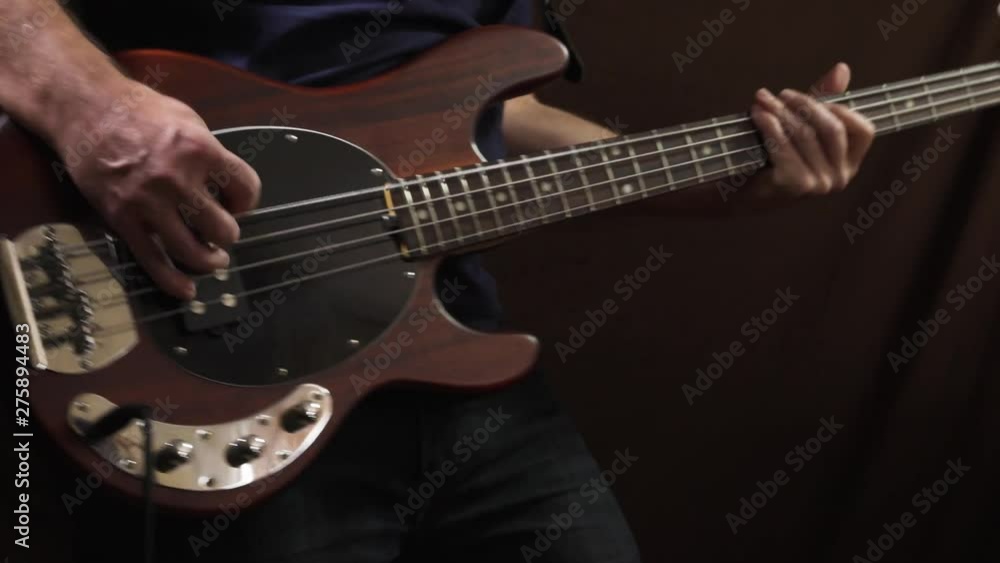 Closeup of hands playing bass guitar Closeup of hands playing bass guitar