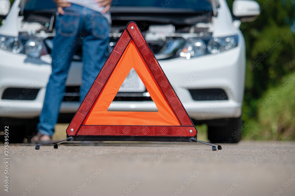 Emergency stop sign and driver near broken car on road. Emergency stop sign and driver near broken car on road.