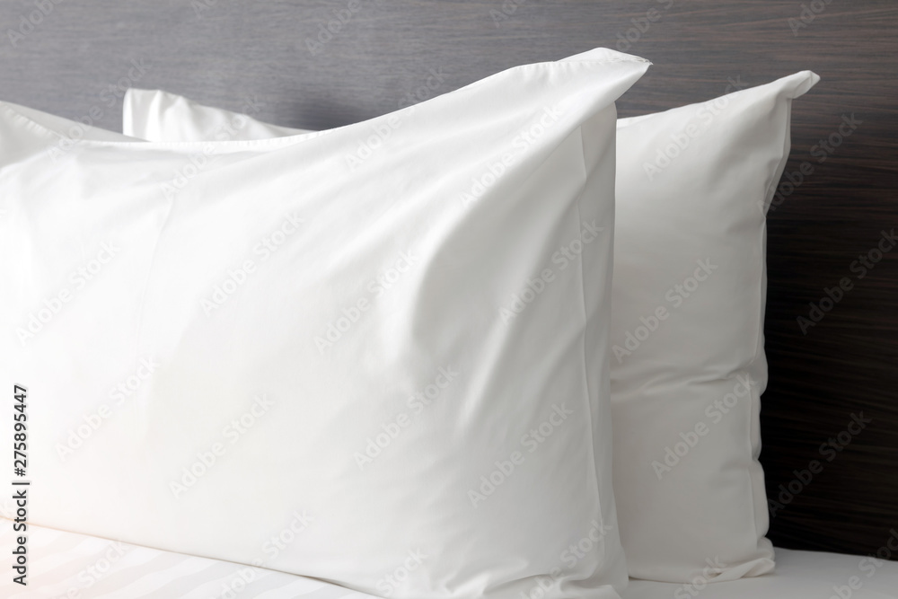 White pillows on comfortable bed in modern bedroom. White pillows on comfortable bed in modern bedroom.