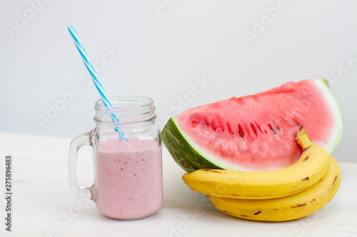 piece of fresh ripe watermelon and banana with cold smoothie