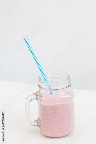 glass jar of milkshake smoothie on white background