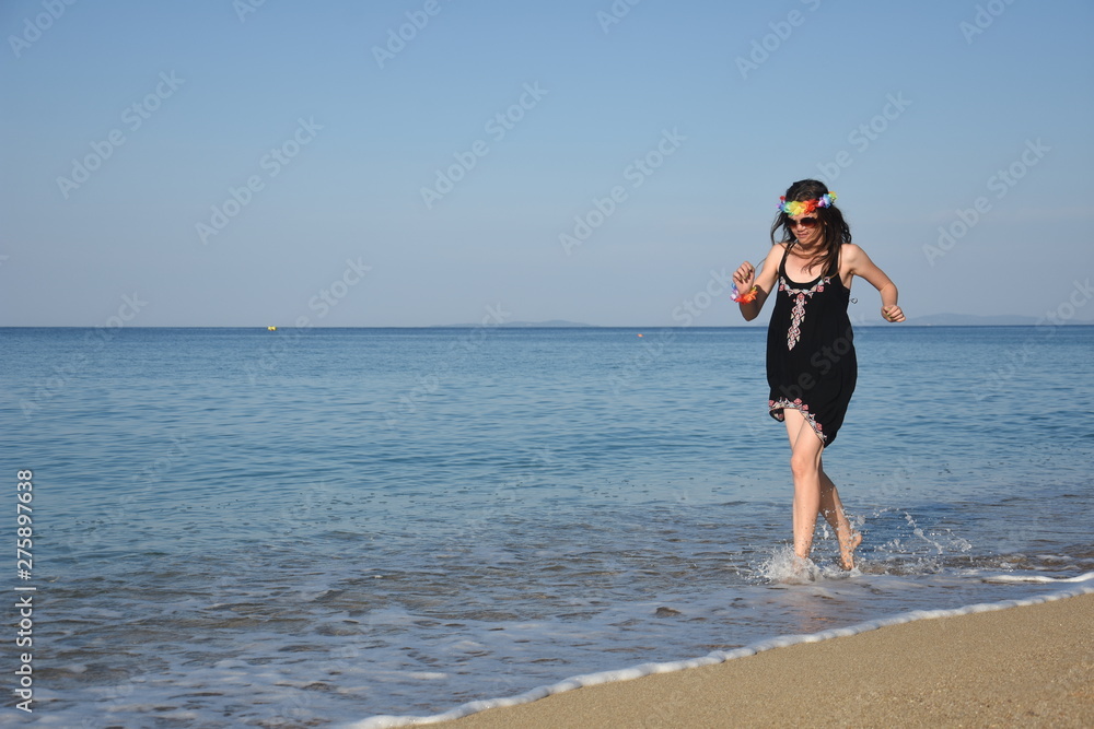 Joyful Woman Running On Edge Of The Sea. Summer Vacation Concept, Single Woman Enjoy At Beach
