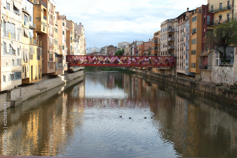Bridge over the Onyar river in Girona with colorful houses on each side