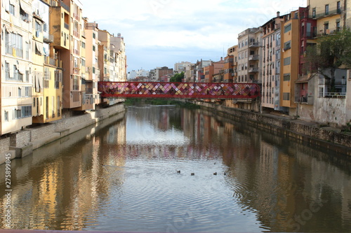 Bridge over the Onyar river in Girona with colorful houses on each side © Marmay