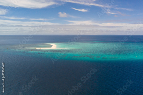 Atoll with an island of white sand. Sand beach island on a coral reef, top view. Tourist route on Camiguin Island, Philippines.
