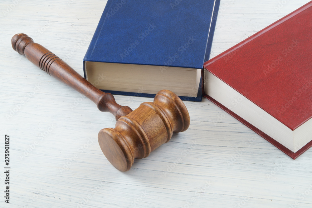 Judge's gavel and blue and red legal books