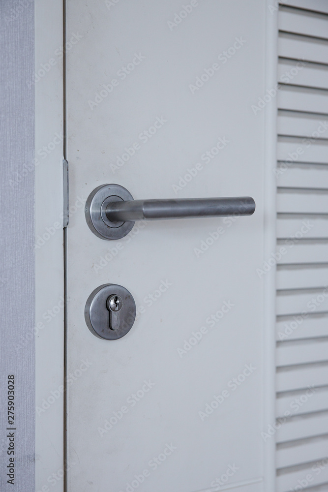 Steel door handle and white door. Steel door handle and white door.