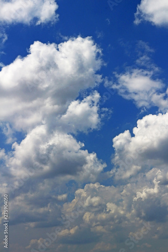 Landscape of cumulonimbus clouds floating in sunny summer sky