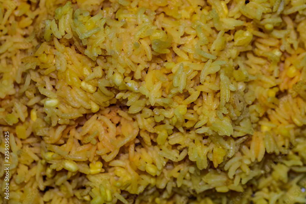 Yellow fried rice served on steel plate looking awesome. Yellow fried rice served on steel plate looking awesome.