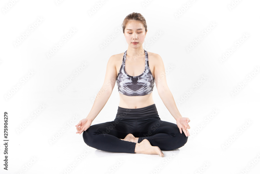 Sporty Asian young woman doing yoga practice isolated on white background.