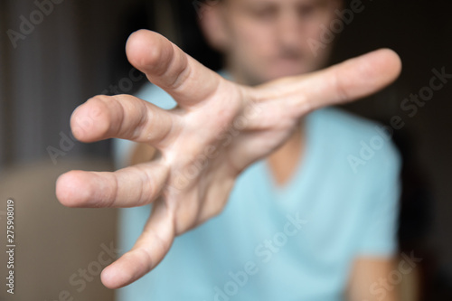 male hand ominously stretching forward