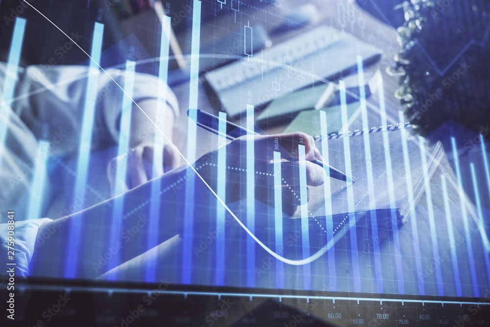 Financial forex charts displayed on woman's hand taking notes background. Concept of research. Double exposure Financial forex charts displayed on woman's hand taking notes background. Concept of research. Double exposure