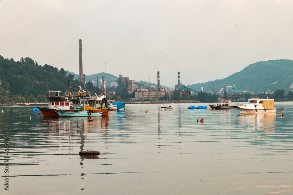 Zonguldak eregli district, fishing boats and erdemir iron and steel factory behind June 24,2019, Eregli, Zonguldak, Turkey