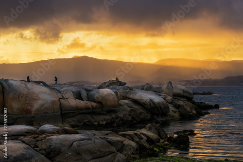 Coastal rocks on stormy sunset