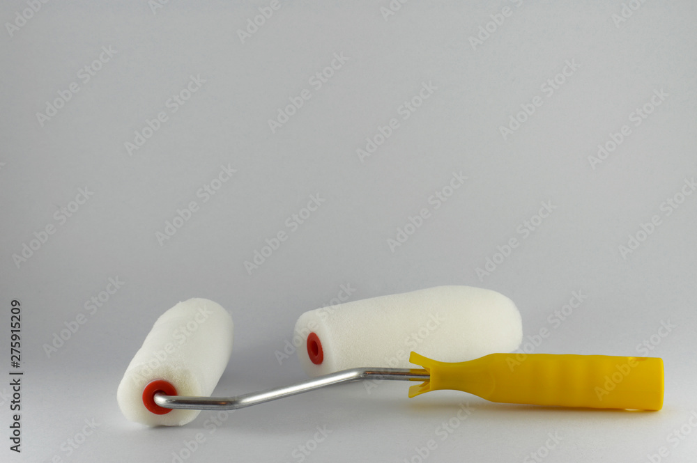 Two isolated, porous rollers for painting walls Two isolated, porous rollers for painting walls