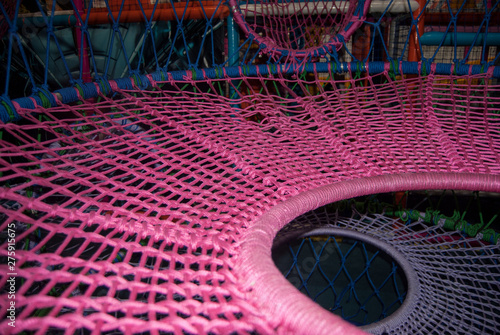 pink macro thread webs on a playground