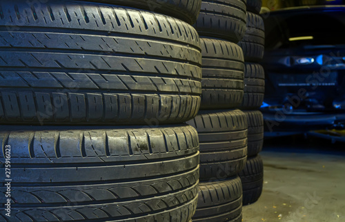 Stacked used auto tires in car service center. Auto repair