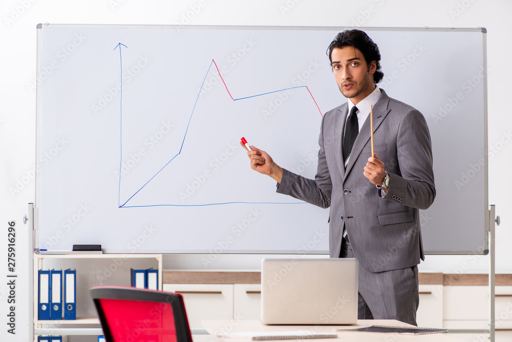Young handsome businessman in front of whiteboard Young handsome businessman in front of whiteboard